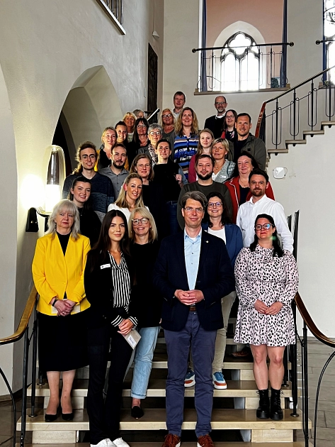 Neue Mitarbeiterinnen und Mitarbeiter bei der Stadt Hildesheim stehen auf der Treppe mit dem Oberbürgermeister © Stadt Hildesheim